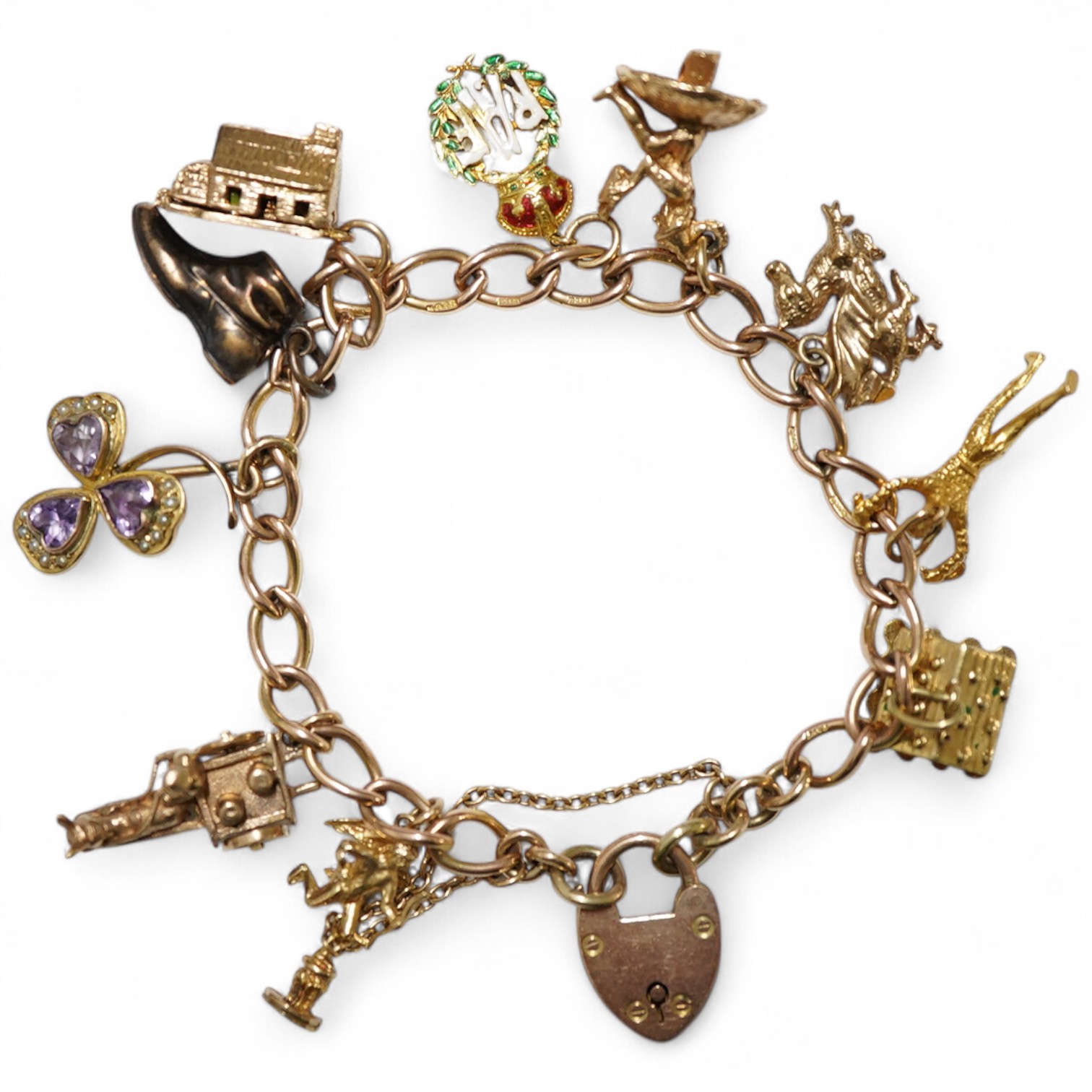 A 9ct gold curb link charm bracelet, hung with ten assorted 9ct gold and yellow metal charms including enamelled R.A.F. charm and a pixie on a toadstool, approximately 14cm, gross weight 31 grams.